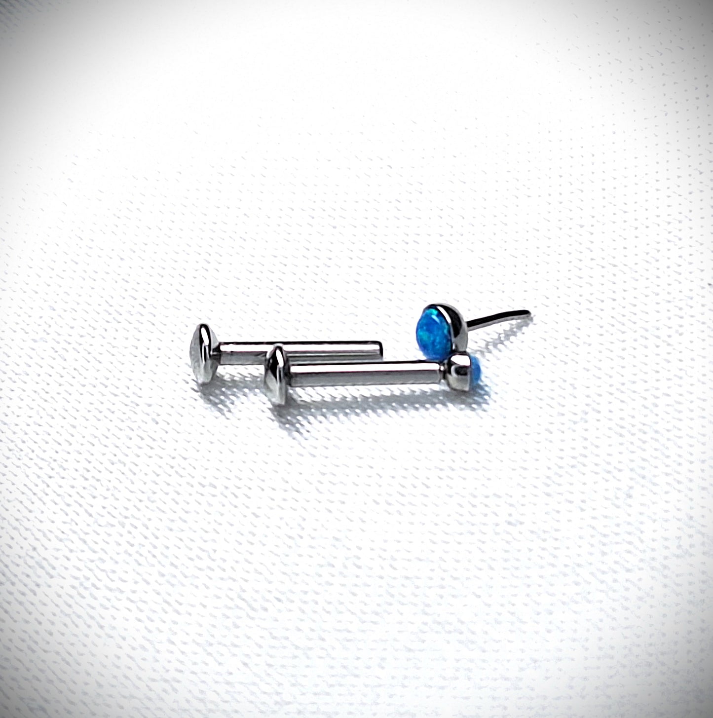 Push in Flat Backed stud with BLUE 2mm or 3mm Opal stone. 5mm, 6mm, 7mm, 8mm, 9mm, 10mm, 11mm, 12mm, 20ga, 18ga, 16ga